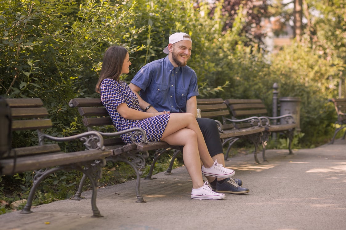 Happy Couple Sitting at the Park Bench 