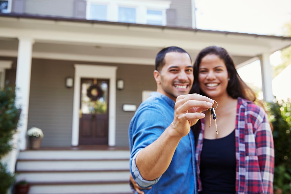 Portrait of Couple Holding Keys to New Home 